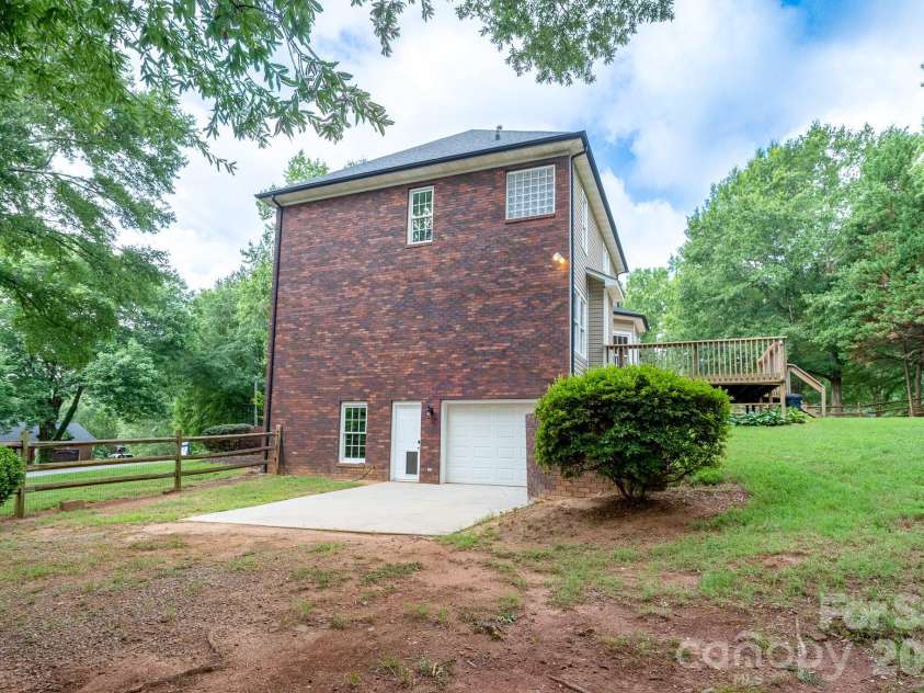 2116 Quail Drive, Concord, NC 28027.  MLS# CAR4389135, YatesRealty ID 33289. Side entrance into basement garage.