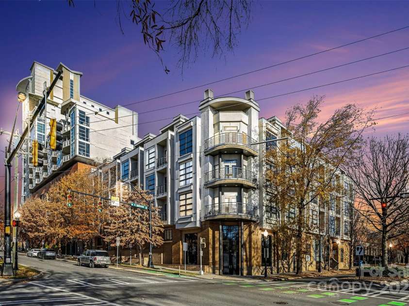 505 6th Street, Charlotte, NC 28202.  MLS# CAR4331119, YatesRealty ID 3329. Exterior – Twilight Street ViewStriking evening view of The Avenue Condominiums at the corner of 6th and Caldwell, highlighting the building’s modern architecture and vibrant Uptown setting.