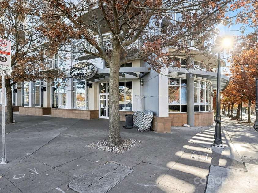 505 6th Street, Charlotte, NC 28202.  MLS# CAR4331119, YatesRealty ID 3329. Street-Level RetailGround-level shot featuring TATTOOZ & BOOZ and the pedestrian-friendly surroundings—showcasing the lively mix of retail and residential convenience.