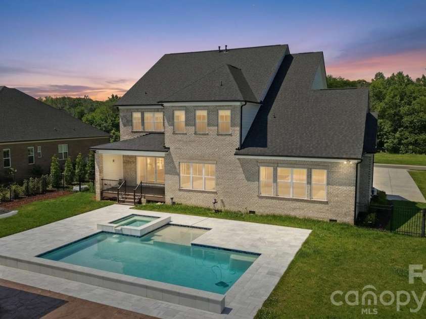 128 Ellison Way, Marvin, NC 28173.  MLS# CAR4394584, YatesRealty ID 33299. Rear Twilight Pool