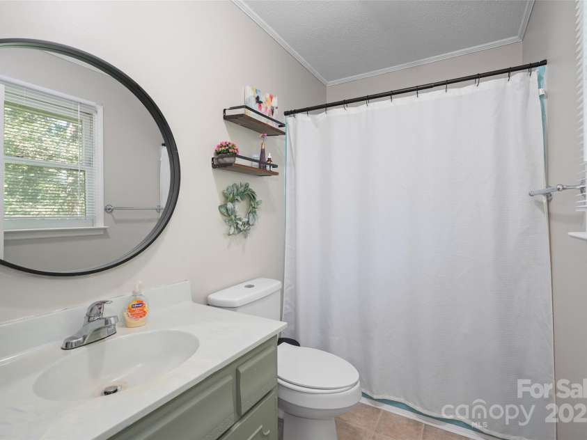 155 Timberlane Drive, Etowah, NC 28729.  MLS# CAR4290050, YatesRealty ID 33313. Primary bedroom ensuite bathroom