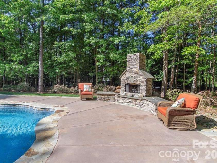 4293 Soaring Eagle Cove Court, Denver, NC 28037.  MLS# CAR4395644, YatesRealty ID 33313. Custom built outdoor fireplace...