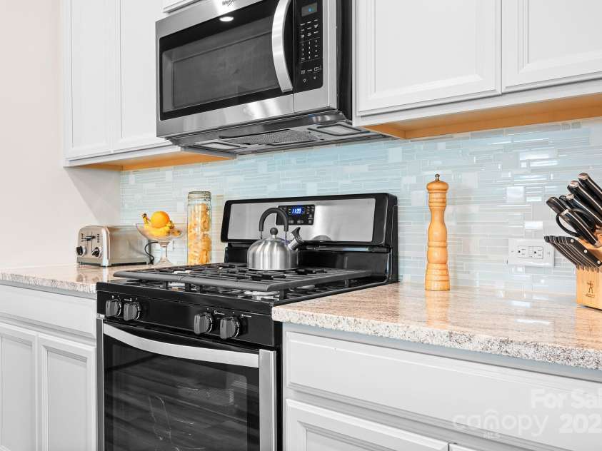 1885 Lotus Lane, Denver, NC 28037.  MLS# CAR4290620, YatesRealty ID 33314. NG gas range with vented MW.  Beautiful backsplash and counter tops!