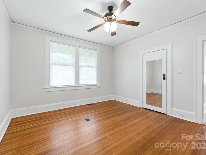 38 Austin Avenue, Asheville, NC 28801.  MLS# CAR4293035, YatesRealty ID 33331. Bedroom 2 offers hardwood floors and ceiling fan
