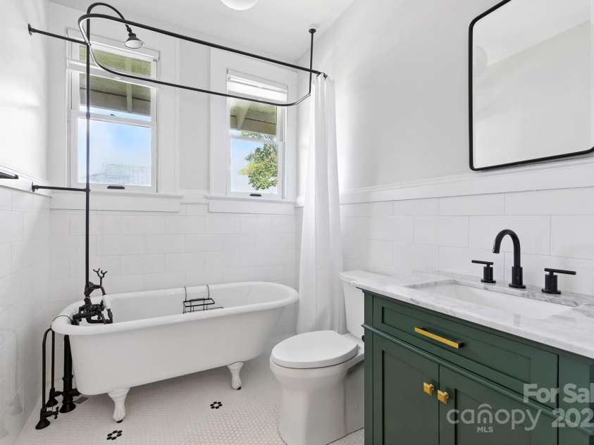 38 Austin Avenue, Asheville, NC 28801.  MLS# CAR4293035, YatesRealty ID 33331. Fully remodeled main bath w/ refinished original tub, stylish new fixtures, and marble countertops