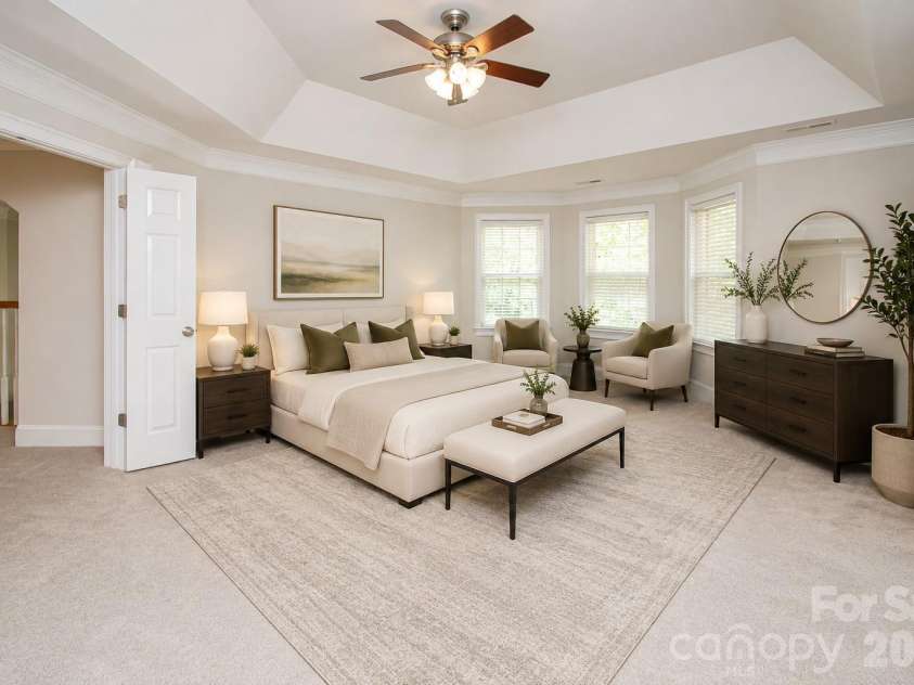 1015 Estate Lane, Matthews, NC 28104.  MLS# CAR4388127, YatesRealty ID 33333. Very spacious primary bedroom with tray ceiling and ceiling fan.