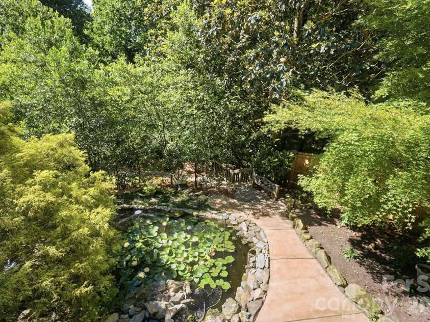723 Walnut Point Drive, Matthews, NC 28105.  MLS# CAR4391716, YatesRealty ID 33345. Fish Pond/View from Deck and Path Leading down to Garden