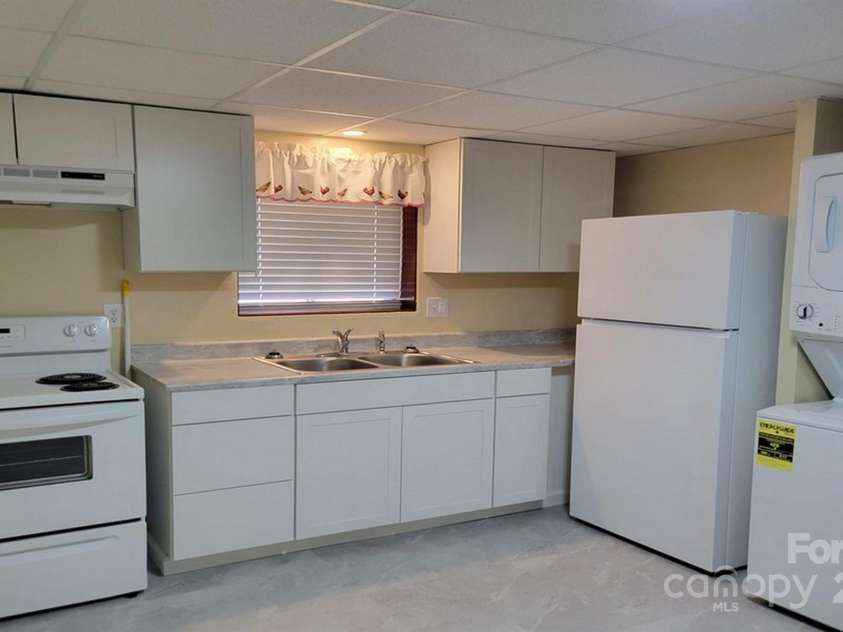 44 17th Avenue Court, Hickory, NC 28601.  MLS# CAR4283456, YatesRealty ID 33367. Kitchen with Stackable W&D