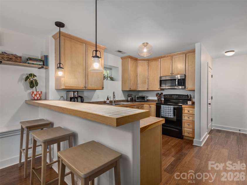 11 Knotty Alder Court, Candler, NC 28715.  MLS# CAR4378917, YatesRealty ID 33370. Kitchen with breakfast bar