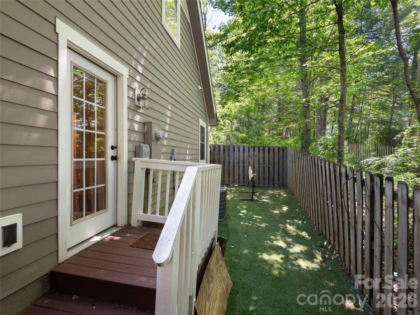 11 Knotty Alder Court, Candler, NC 28715.  MLS# CAR4378917, YatesRealty ID 33370. Private back yard with artificial turf