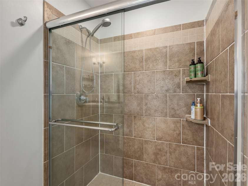 11 Knotty Alder Court, Candler, NC 28715.  MLS# CAR4378917, YatesRealty ID 33370. Walk-in shower in primary bath