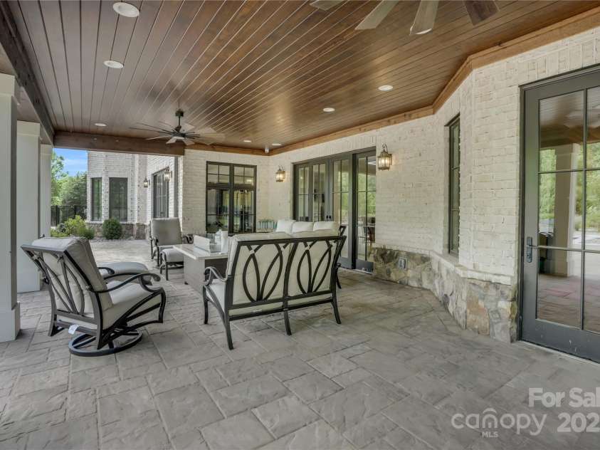 1430 Rosehill Drive, Waxhaw, NC 28173.  MLS# CAR4274652, YatesRealty ID 33396. Covered patio off basement overlooking the amazing pool