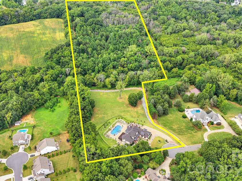 1430 Rosehill Drive, Waxhaw, NC 28173.  MLS# CAR4341859, YatesRealty ID 33396. Property goes into the woods where the owner has laid out trails for biking, hiking or hores ridding