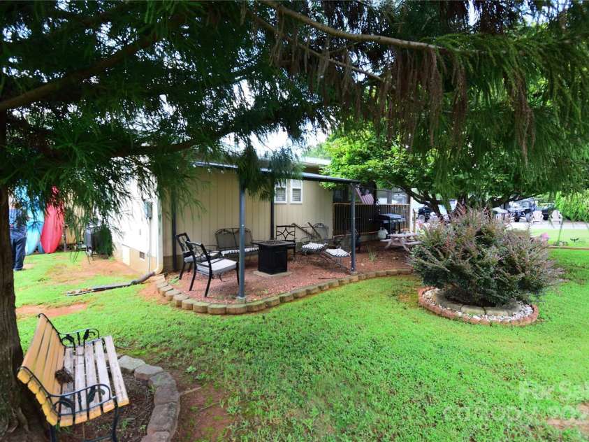 101 Hummingbird Circle, New London, NC 28127.  MLS# CAR4293421, YatesRealty ID 33406. Spend time under the side pergula looking into the large yard.