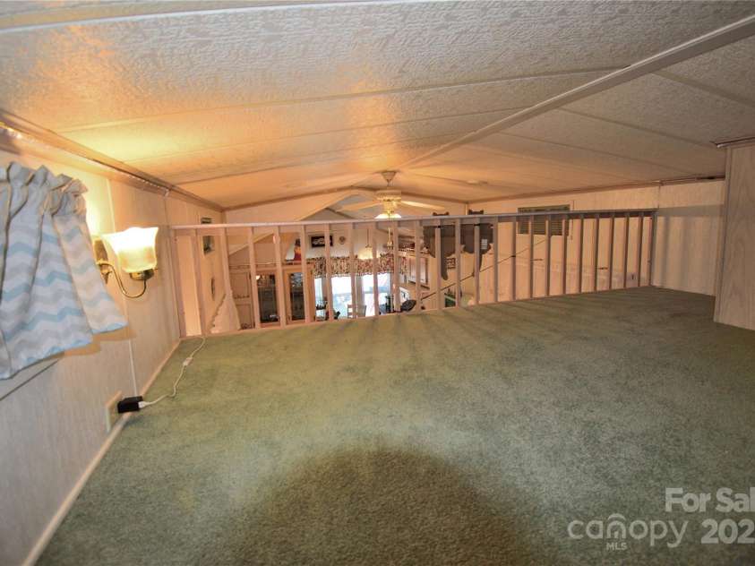 101 Hummingbird Circle, New London, NC 28127.  MLS# CAR4293421, YatesRealty ID 33406. Upstairs loft facing the living room overlook