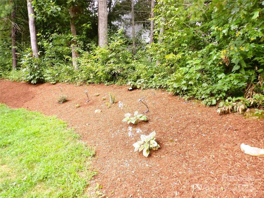 31 Mcgee Hill Road, Fairview, NC 28730.  MLS# CAR4289584, YatesRealty ID 33434. Side yard garden