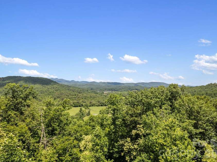 376 Stoney Brook Road, Penrose, NC 28766.  MLS# CAR4397828, YatesRealty ID 33434. Expansive mountain and valley views from the sunroom
