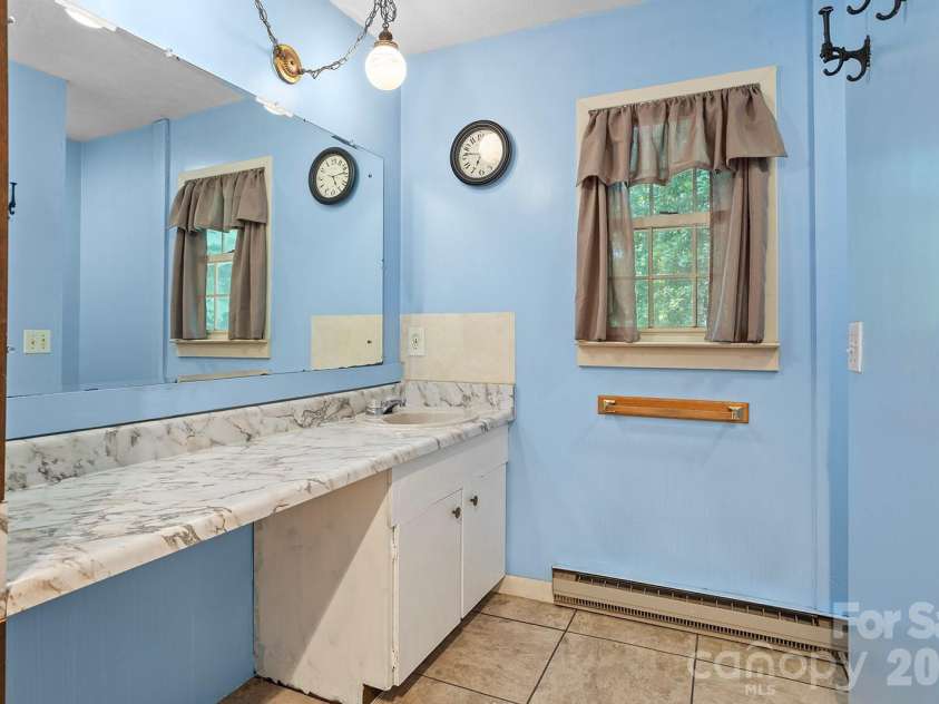 376 Stoney Brook Road, Penrose, NC 28766.  MLS# CAR4397828, YatesRealty ID 33434. Main level bathroom
