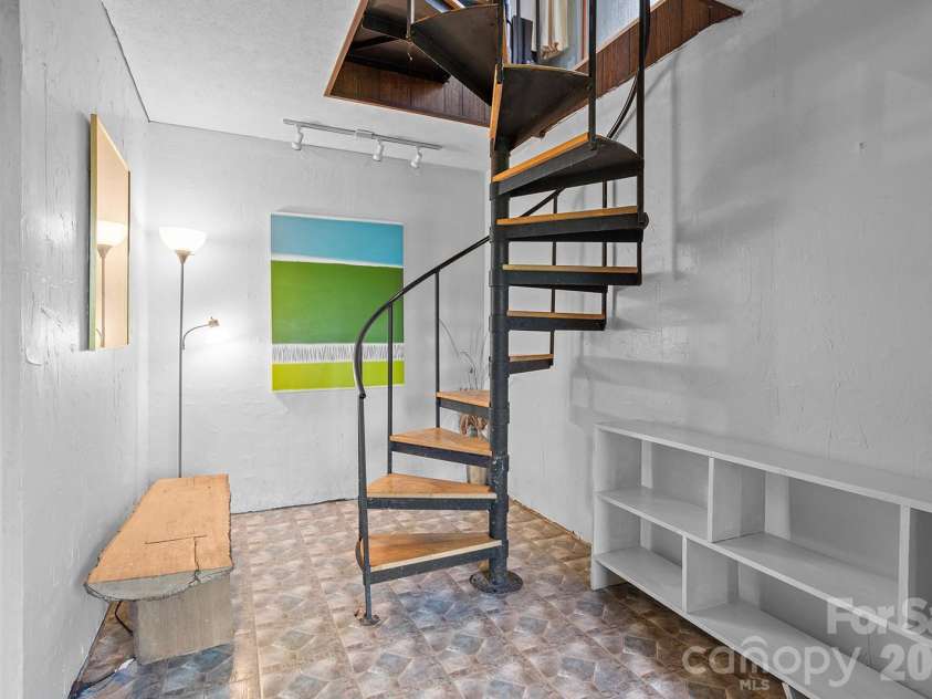 376 Stoney Brook Road, Penrose, NC 28766.  MLS# CAR4397828, YatesRealty ID 33434. Spiral staircase and basement entry
