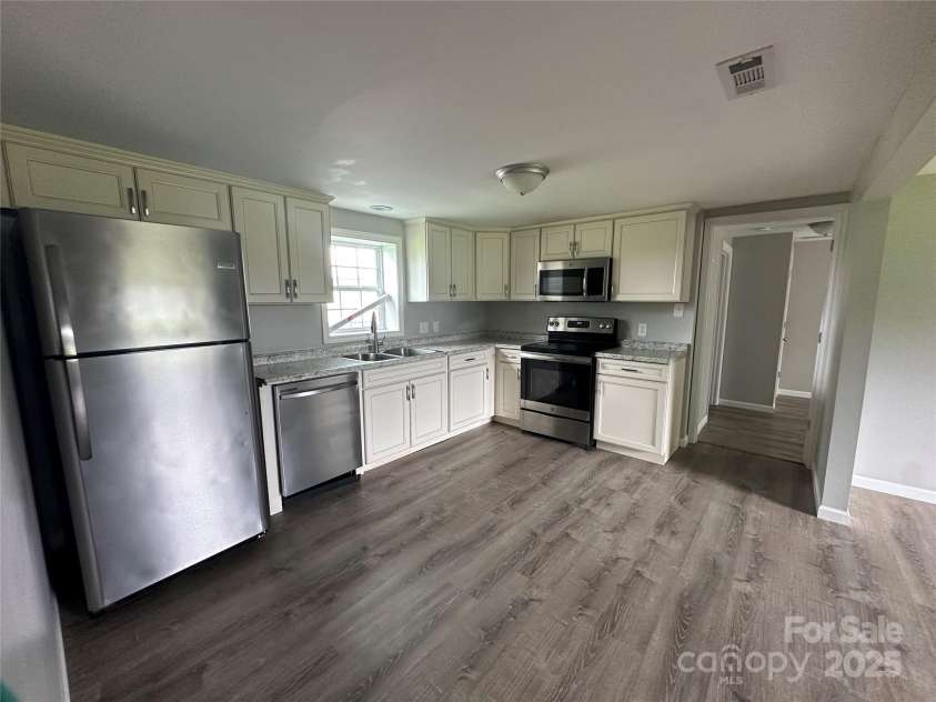 2387 Peeler Road, Vale, NC 28168.  MLS# CAR4290604, YatesRealty ID 33435. Kitchen view looking into primary suite