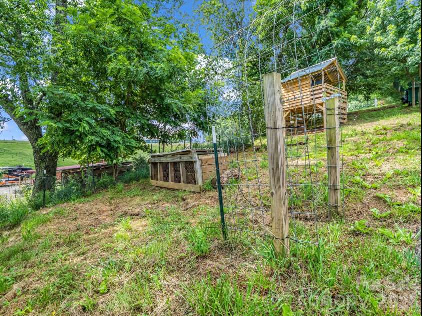 18 Old Chapman Place, Leicester, NC 28748.  MLS# CAR4398287, YatesRealty ID 33451. Rabbit hutch and additional garden