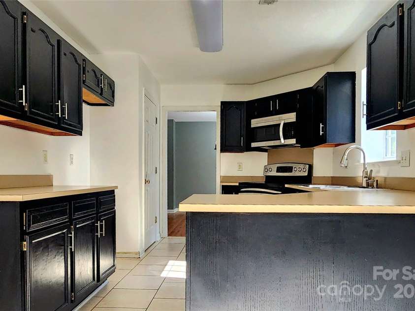 3108 Leicester Drive, Matthews, NC 28104.  MLS# CAR4273799, YatesRealty ID 33452. Kitchen from Eat-in area