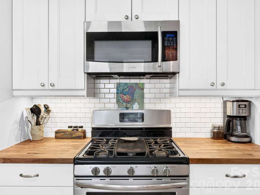 15 Westgate Road, Asheville, NC 28806.  MLS# CAR4397245, YatesRealty ID 33456. Five-Burner Range and Subway-Tile Backsplash