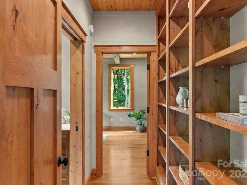147 Brantley Branch Lane, Waynesville, NC 28786.  MLS# CAR4275100, YatesRealty ID 3349. Built-in bookshelf wall