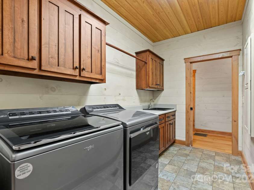 147 Brantley Branch Lane, Waynesville, NC 28786.  MLS# CAR4275100, YatesRealty ID 3349. Wet sink and hanging area plus washer and dryer convey