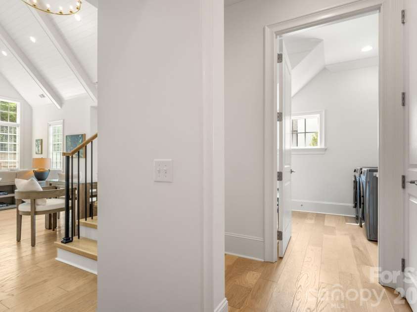 1355 Kings Drive, Charlotte, NC 28207.  MLS# CAR4391517, YatesRealty ID 33496. Entry from Garage, looking into laundry room then into Great room with vaulted ceiling.