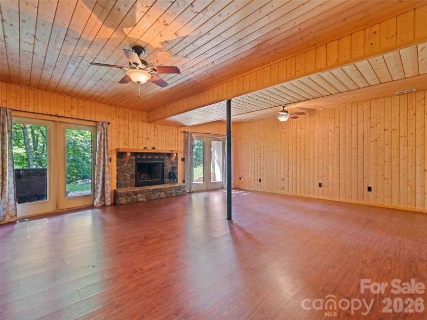 51 Stony Pond Lane, Canton, NC 28716.  MLS# CAR4380850, YatesRealty ID 33499. Downstairs den with wood burning fireplace insert