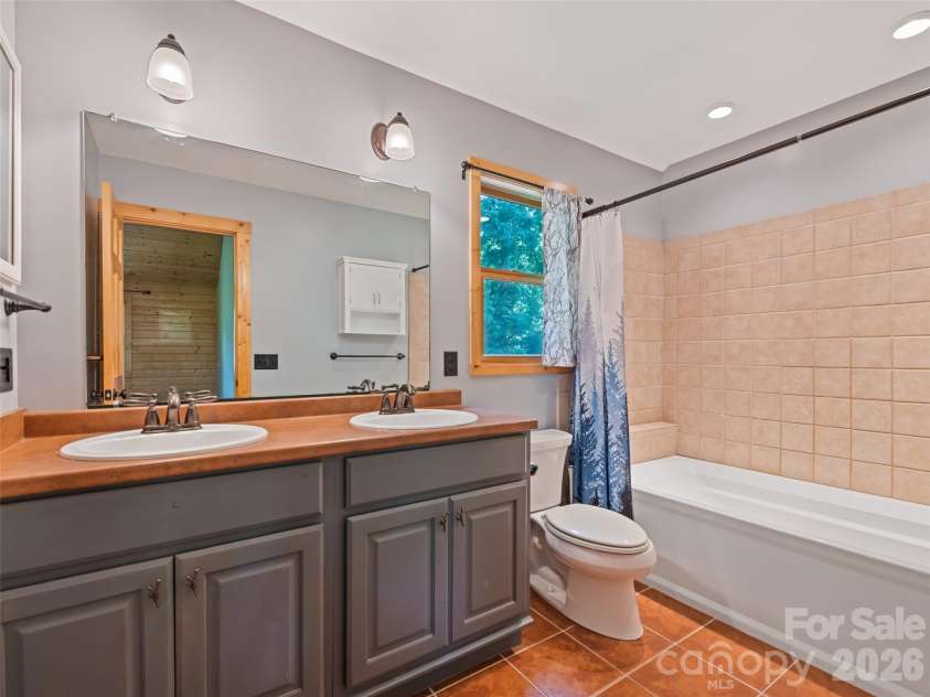 51 Stony Pond Lane, Canton, NC 28716.  MLS# CAR4380850, YatesRealty ID 33499. Primary bathroom with natural light and solid finishes 