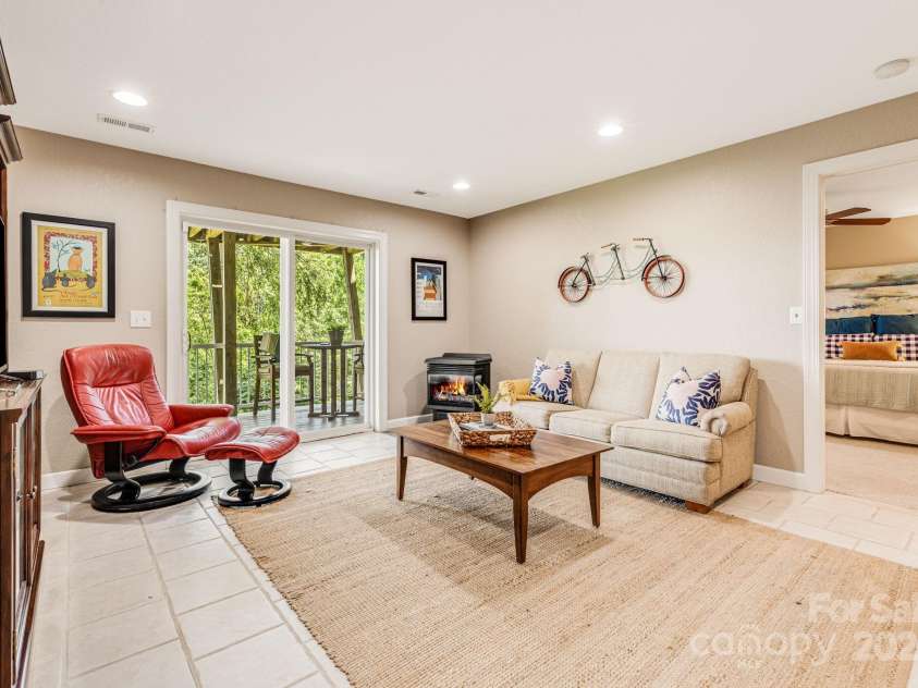 930 Sunlight Ridge Drive, Hendersonville, NC 28792.  MLS# CAR4281569, YatesRealty ID 33501. Lower level family room with walkout deck