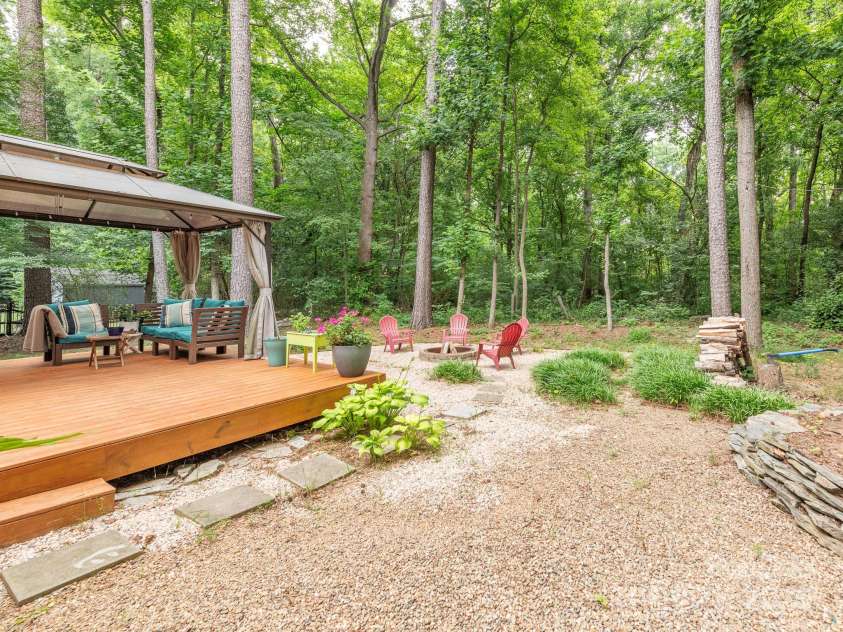 3102 Peggy Ridge Terrace, Matthews, NC 28105.  MLS# CAR4278546, YatesRealty ID 33508. Backyard w/ deck & firepit