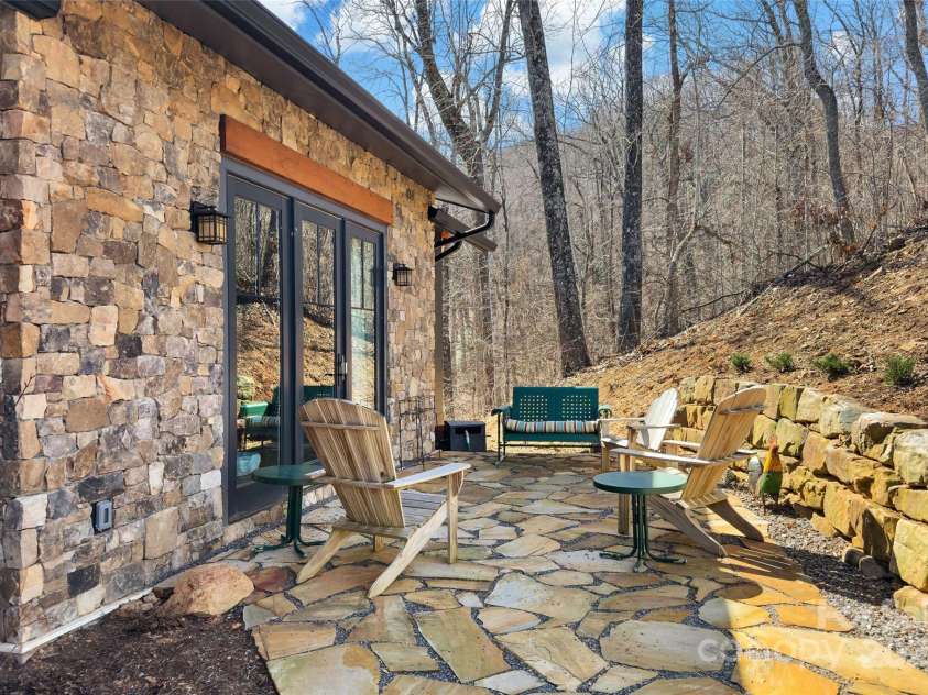 159 Settings Boulevard, Black Mountain, NC 28711.  MLS# CAR4237970, YatesRealty ID 3351. Patio off of primary bedroom and den
