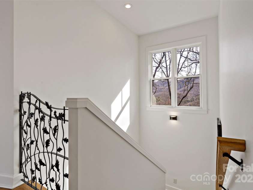 159 Settings Boulevard, Black Mountain, NC 28711.  MLS# CAR4237970, YatesRealty ID 3351. Stairway boasts custom iron work from local artisan