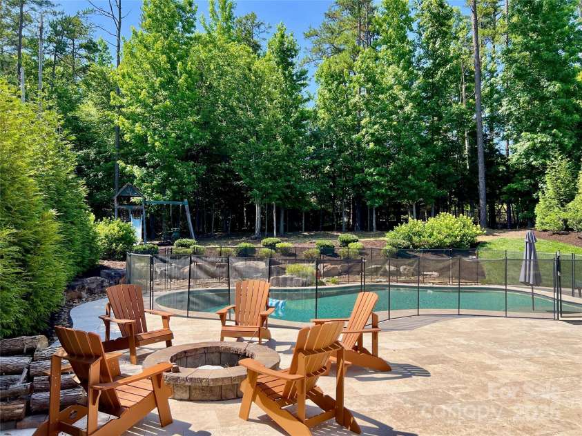 1906 Pensco Pond Court, Waxhaw, NC 28173.  MLS# CAR4266619, YatesRealty ID 33515. Fire Pit, Pool, Playground and trees