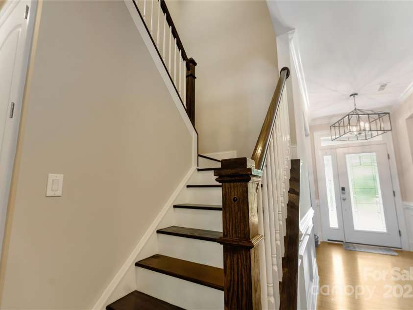 1906 Pensco Pond Court, Waxhaw, NC 28173.  MLS# CAR4266619, YatesRealty ID 33515. Hardwood Stairs going to upper level