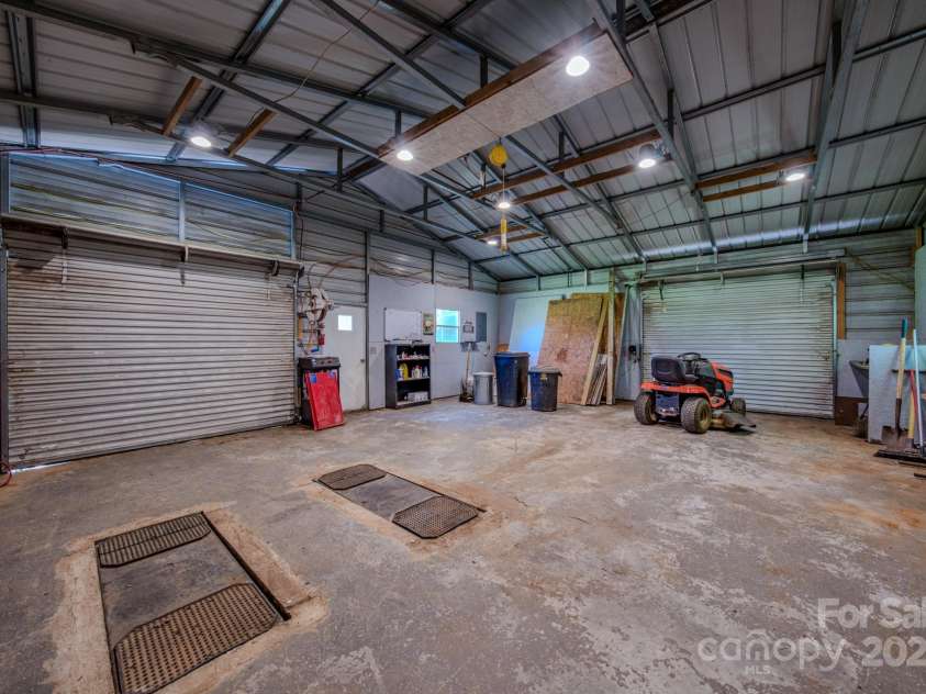 2606 Bear Creek Road, Marshall, NC 28753.  MLS# CAR4287238, YatesRealty ID 33517. Workshop interior with two overhead doors