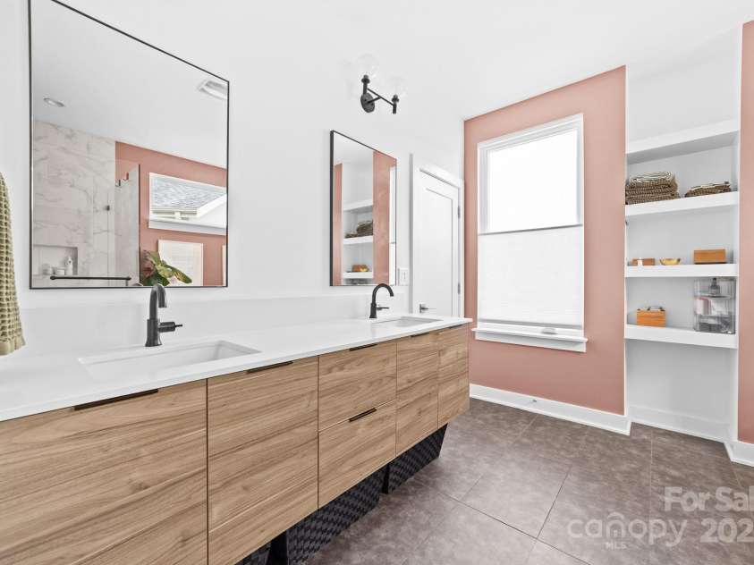 102 Mattoon Street, Charlotte, NC 28216.  MLS# CAR4291152, YatesRealty ID 33532. Contemporary floating double vanity, large framed mirrors, natural light, built ins... this bathroom is STACKED