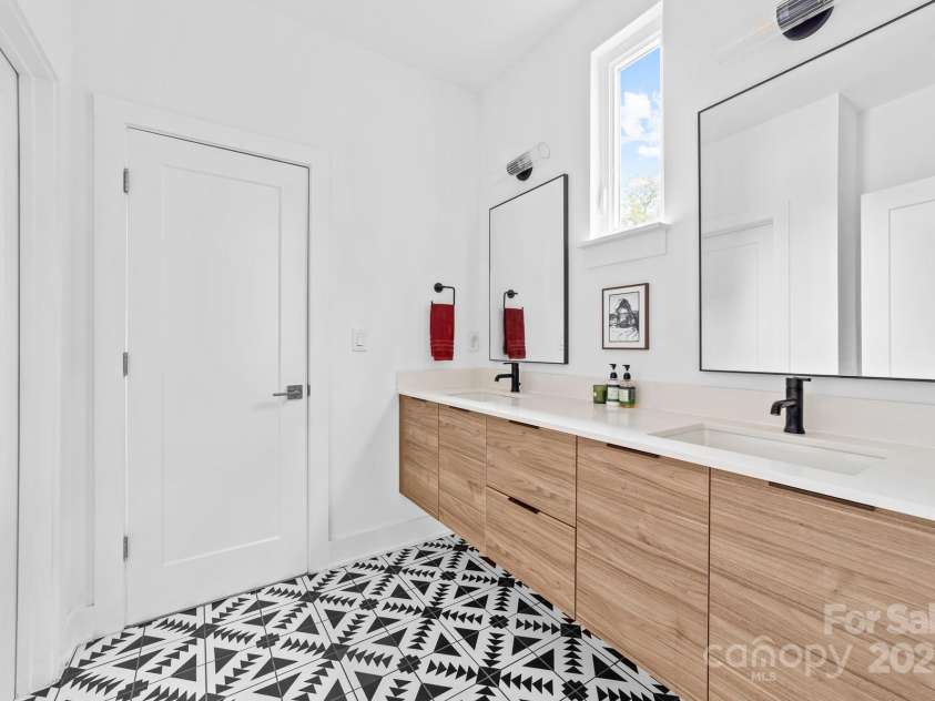 102 Mattoon Street, Charlotte, NC 28216.  MLS# CAR4291152, YatesRealty ID 33532. Jack and jill secondary bath with double floating vanity and the funnest, that's right FUNNEST, tile floors!