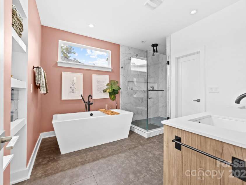 102 Mattoon Street, Charlotte, NC 28216.  MLS# CAR4291152, YatesRealty ID 33532. Soak up LUXURY in the primary ensuite with soaking tub and rain shower head.