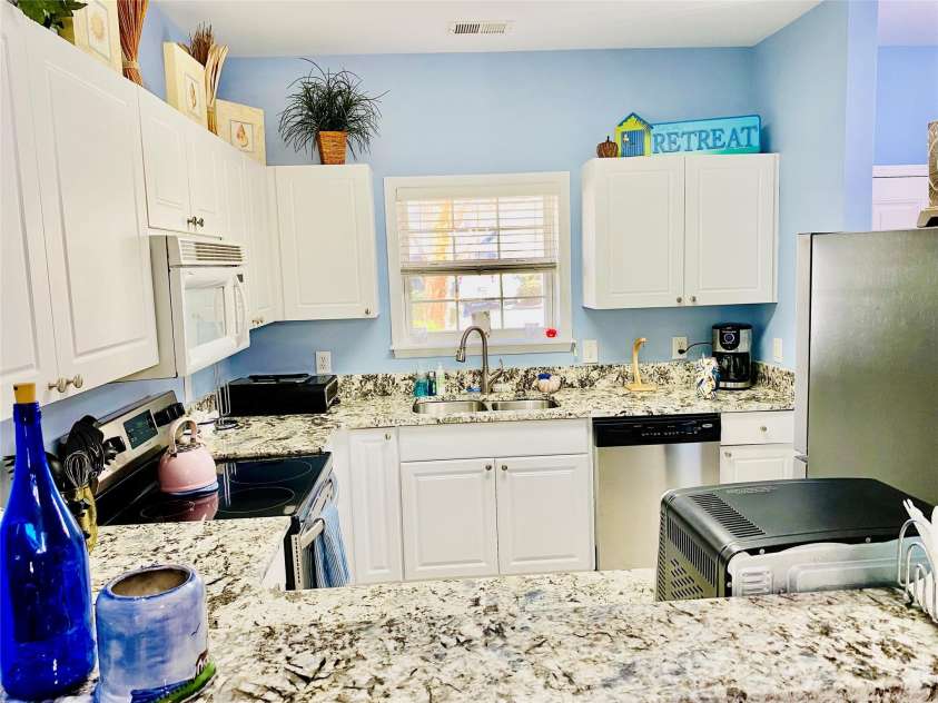 5825 Catalina Drive, North Myrtle Beach, SC 29582.  MLS# CAR4301398, YatesRealty ID 3354. Bar counter opens to kitchen.