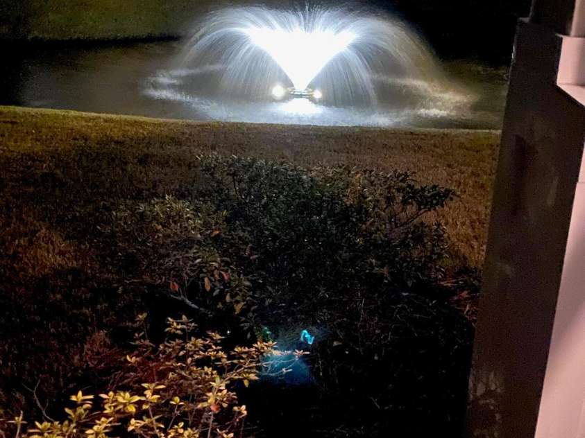 5825 Catalina Drive, North Myrtle Beach, SC 29582.  MLS# CAR4301398, YatesRealty ID 3354. Pond fountain at night