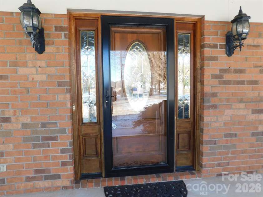 175 Briarfield Drive, Mooresville, NC 28115.  MLS# CAR4342091, YatesRealty ID 3356. Beautiful wooden framed front door and Carriage lights for plenty of light for night time entry