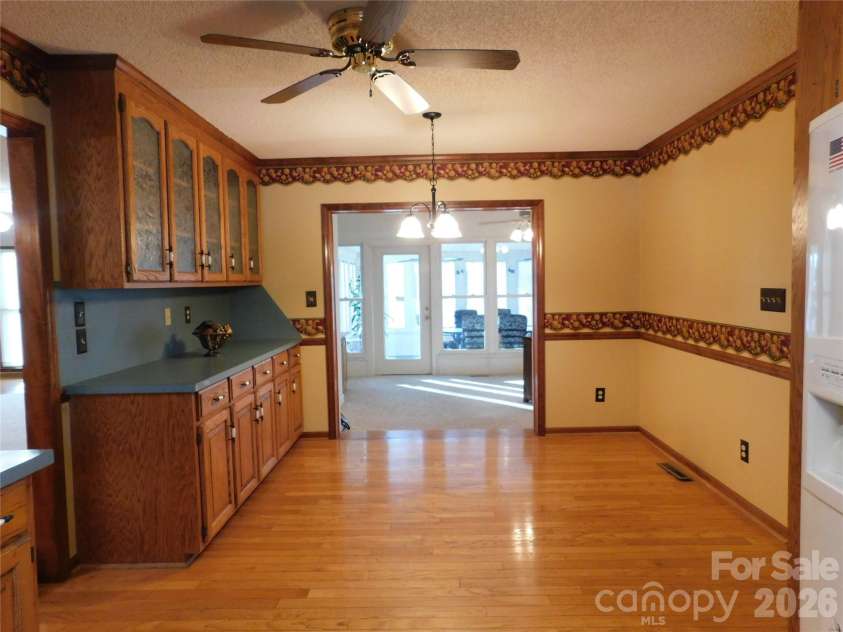 175 Briarfield Drive, Mooresville, NC 28115.  MLS# CAR4342091, YatesRealty ID 3356. From the kitchen looking at the breakfast area you can see the built in China/Office/Craft built ins