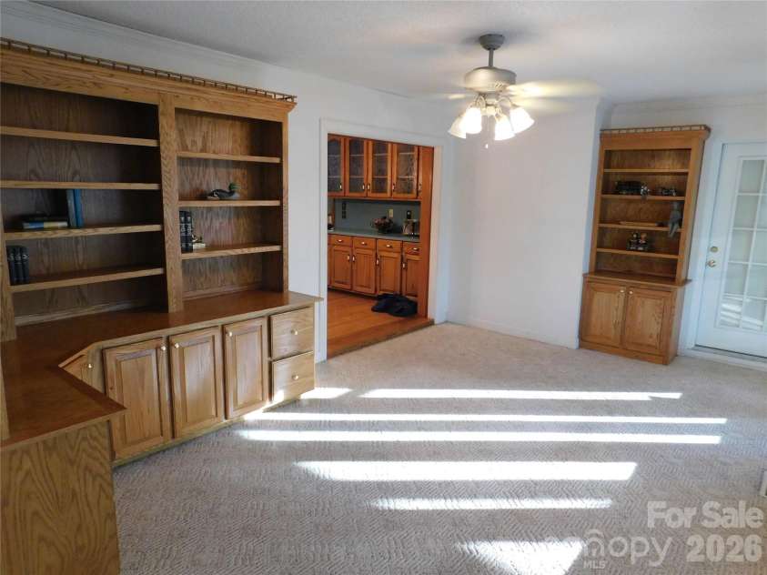 175 Briarfield Drive, Mooresville, NC 28115.  MLS# CAR4342091, YatesRealty ID 3356. Off of the kitchen you flow into the family room , or study maybe a home office or a book enthusiast nook complete with beautiful wooden book/Collections display with storage areas. Natural light shines in through th