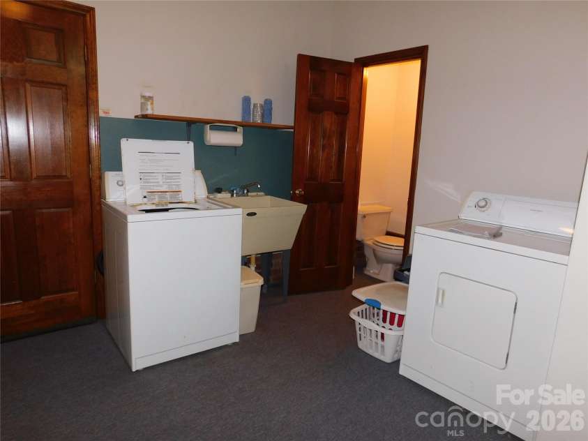 175 Briarfield Drive, Mooresville, NC 28115.  MLS# CAR4342091, YatesRealty ID 3356. Off the flex room heading to the garage is the laundry room/ mud room. It also has a toilet for your convenience  sink is located right outside toilet area . 