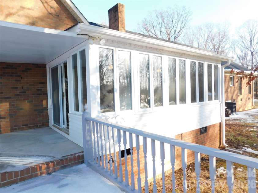 175 Briarfield Drive, Mooresville, NC 28115.  MLS# CAR4342091, YatesRealty ID 3356. Outside view of sunroom I am on the deck/ perfect for grilling out, you can also see the covered area leading into the sunroom from outside