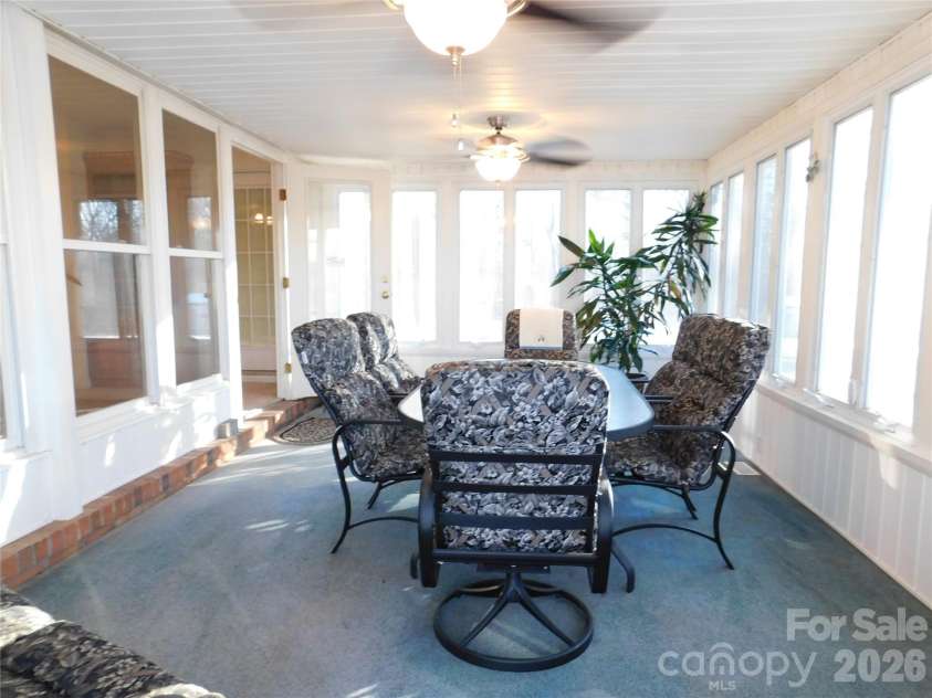 175 Briarfield Drive, Mooresville, NC 28115.  MLS# CAR4342091, YatesRealty ID 3356. The heated and cooled Sunroom. Two ceiling fans with lights for plenty illumination at night offers tons of natural light. Large area for gatherings, study/ crafts ect